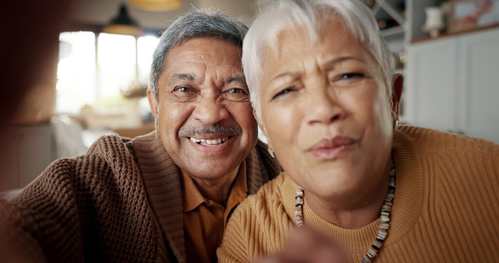 Face, video call or senior couple in living room talking on digital connection, virtual app or soci.