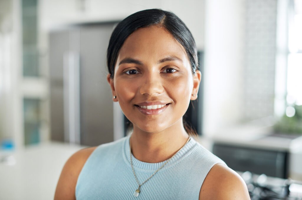 Shot of an attractive young woman standing alone in her kitchen during the day.