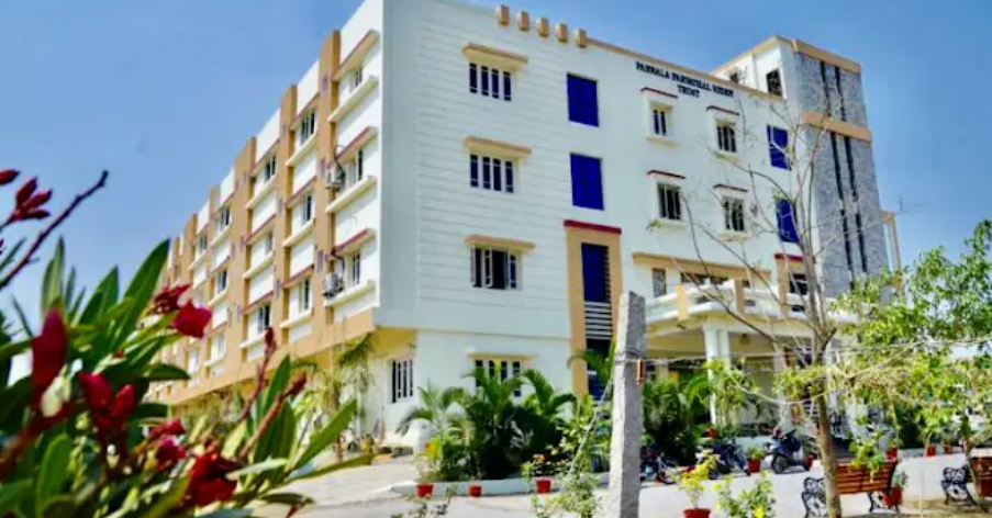 Exterior view of the PP Reddy Retirement Homes building campus with green surroundings.